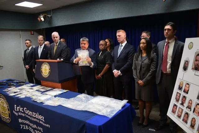 Acting Brooklyn District Attorney Eric Gonzalez, with drugs on the table.